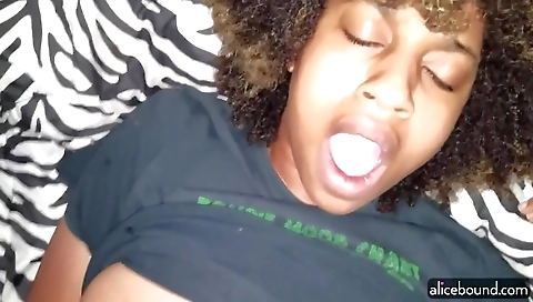 Two horny black and white babes play in the bed with toys