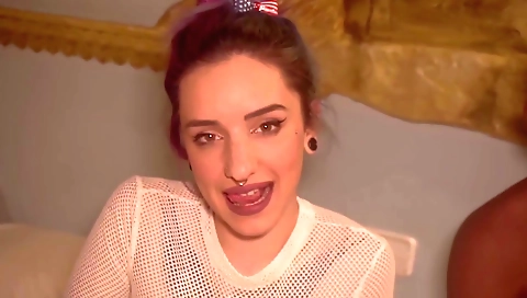 A tattooed teen in stockings and a sexy dress in this video